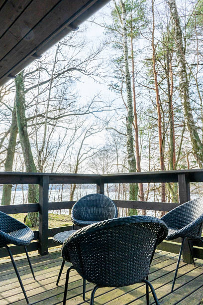 istock Outdoor terrace with wicker chairs and lake view 2244768763