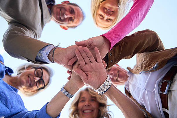istock Group of senior friends stacking hands for teamwork 2244768818