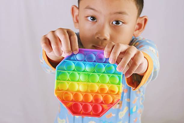 istock Boy Showing Pop It Toy Toward Camera 2244769649
