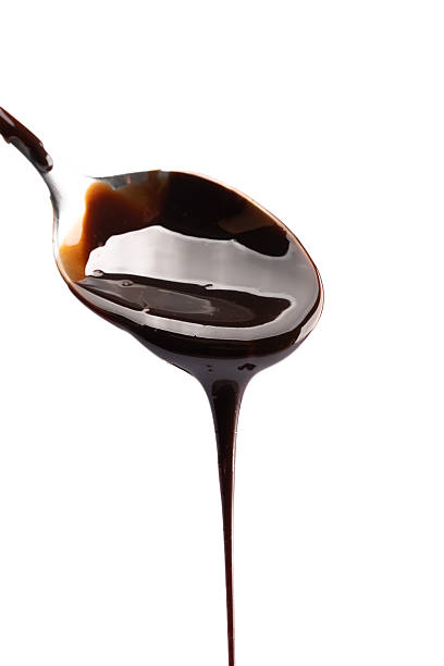 istock Melted chocolate or chocolate sauce dripping from a metal spoon 2244770053