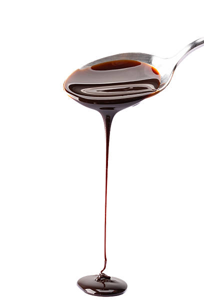istock Melted chocolate or chocolate sauce dripping from a metal spoon 2244770077