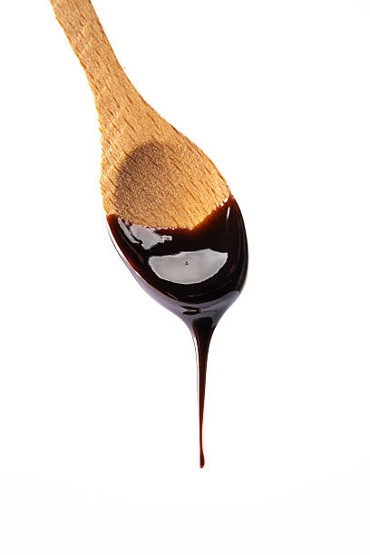 istock Melted chocolate or chocolate sauce dripping from a wooden spoon 2244770084