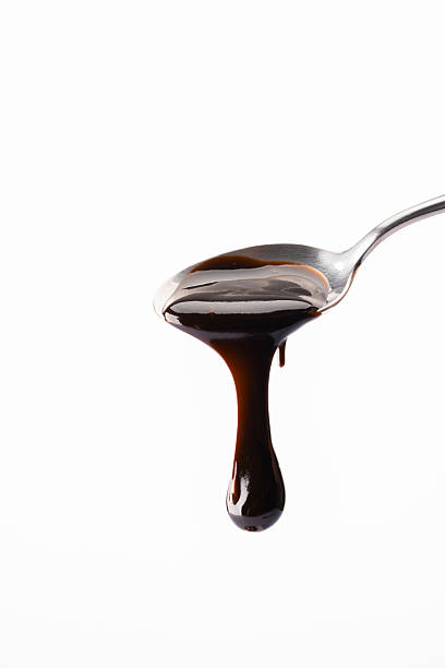 istock Melted chocolate or chocolate sauce dripping from a metal spoon 2244770623