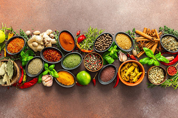 istock A stunning spread of fresh spices and herbs, meticulously arranged on a deep brown backdrop, capturing their vibrant colors and tantalizing aromas 2244773572
