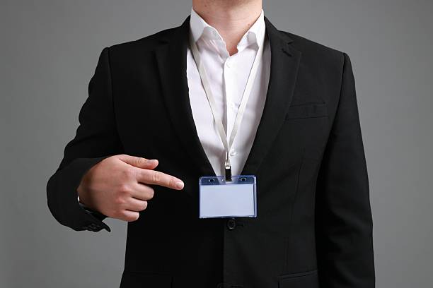 istock Man with blank badge on gray background, closeup 2244773658