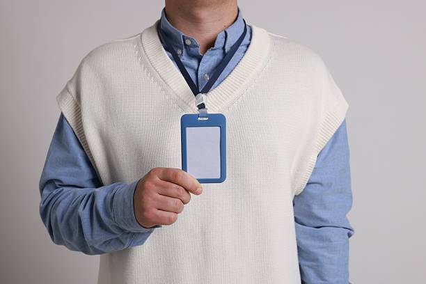istock Man with blank badge on gray background, closeup 2244773676