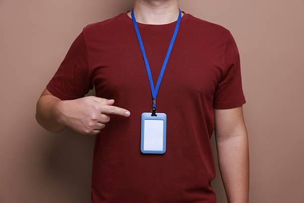 istock Man with blank badge on brown background, closeup 2244773717