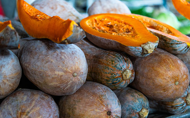 istock Stacking fresh butternut squash at a market for sale 2244775141