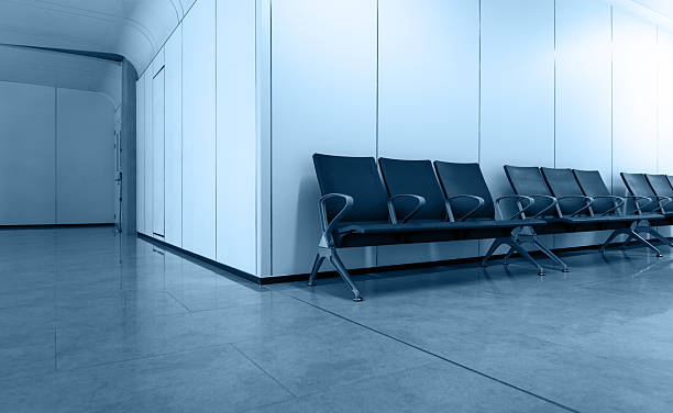 istock Empty corridor in modern hospital with waiting area 2244775584