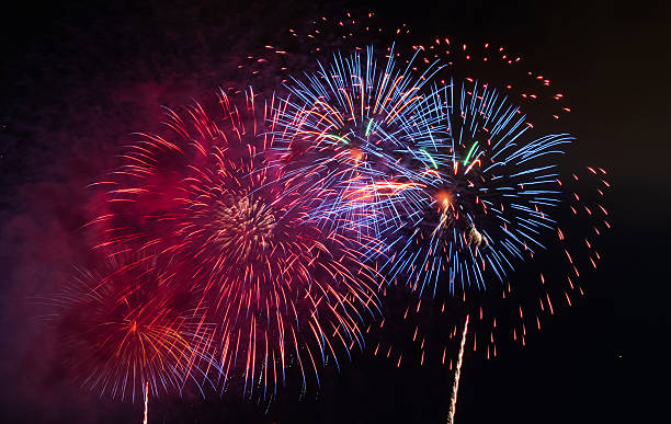 istock Beautiful fireworks display on dark sky background 2244775592
