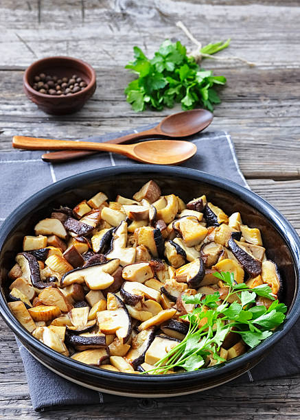 istock fried wild porcini mushrooms, ceps in a black bowl 2244777213