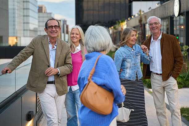 istock Senior friends talking and smiling outdoors in urban setting 2244780187