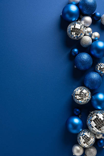 istock Vertical blue Christmas decoration with shiny ornaments and silver disco balls on a deep blue background evokes festive warmth celebration winter magic New Year wishes holiday glow style elegance 2244780480