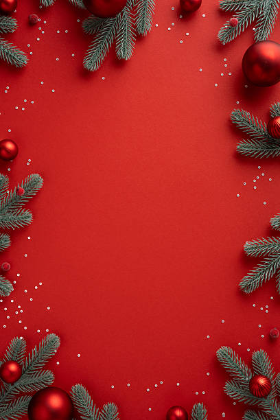 istock Vertical festive red background with pine branch ornaments berries snow and sparkle ready for Christmas and New Year greeting messages 2244780496