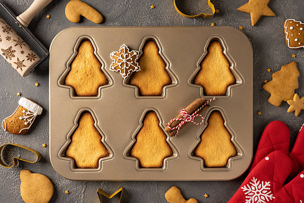 istock A baking scene features tree shaped cookies in a metal mold, star decorations, and festive trim. Cinnamon scent fills the air as holiday gifts and warm memories come to life 2244780555