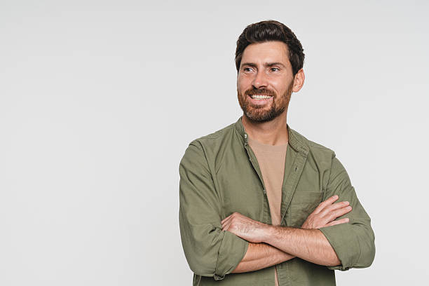 istock Young Caucasian man with beard wearing casual standing over white background happy face smiling with crossed arms looking aside for empty space advertisement promotion. Positive person. 2244780882