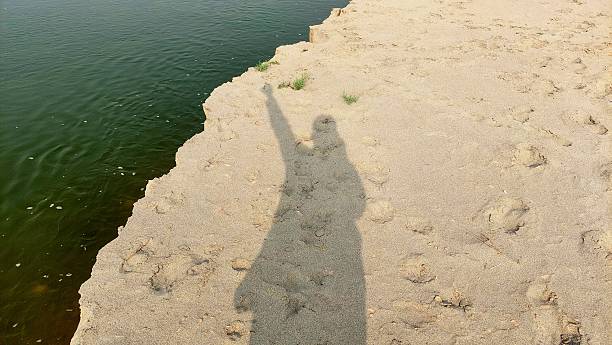istock Overhead Photography Featuring Long Shadow On Sandy Riverbank 2244781512