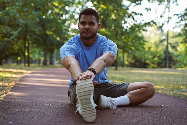 istock Young athletic man stretching in the park 2244781894