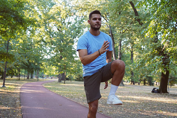 istock Young athletic man stretching in the park 2244781978