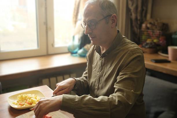 istock Man cutting potatoes and carrots 2244783437