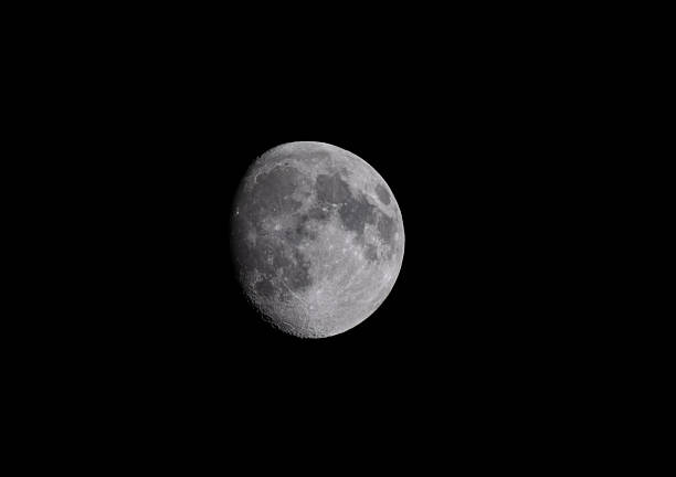 A waxing gibbous Moon in the night sky.