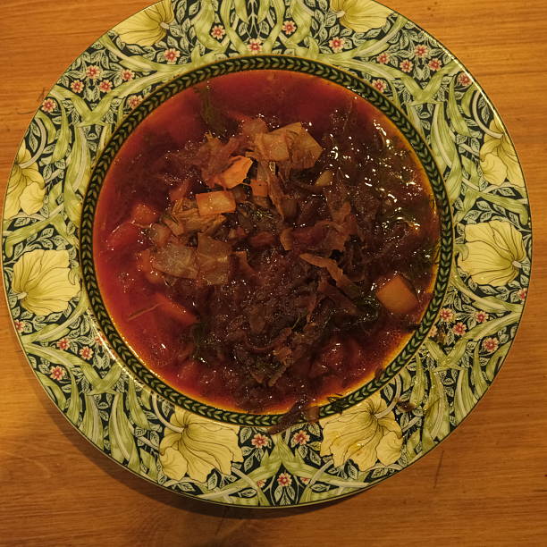 Happy end - Borsch soup in the plate - ready to taste, healthy soup made of meat and vegetables, traditional Russian meal, plate on table