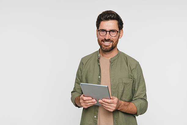istock Tablet, smile and studio with man portrait on white background copy space. Internet, online and communication online app, website software, male person on technology for e-commerce, e-learning 2244783804