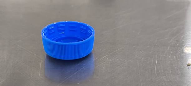 istock Blue soda bottle caps on a stainless steel table 2244783946