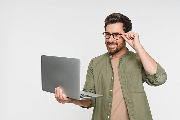 istock Laptop, smile and studio with man portrait on white background copy space. Internet, online and communication online app, website software, male person on technology for e-commerce, e-learning 2244785269