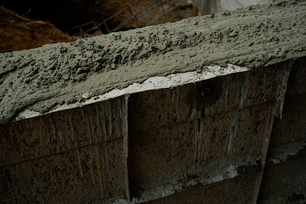 Reinforcement Steel Rebar Cage and Concrete Wall Foundation during Construction. Structural Engineering Detail.