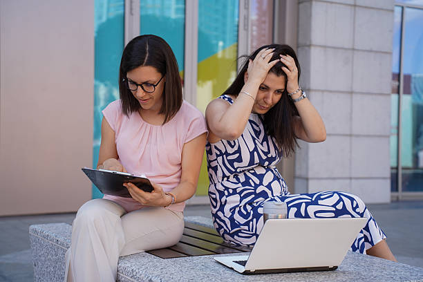 istock Two young women working online outdoors 2244786366
