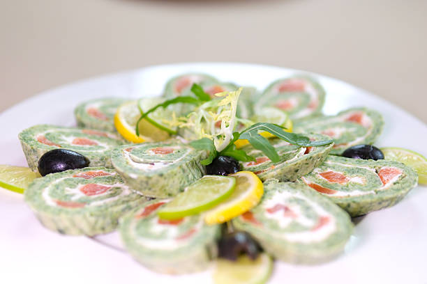 Green roll of spinach and cream cheese close up. Gourmet restaurant menu. Selective focus. High quality photo