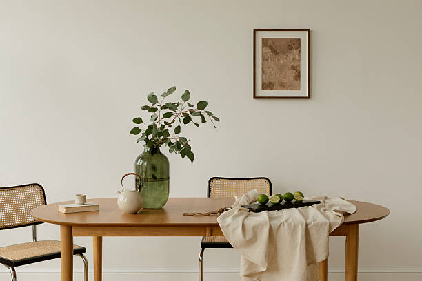 istock Bright interior with minimalist setup, a dining table styled with greenery, teapot, and limes on neutral linen. Scandinavian and Japanese design influences. 2244790073