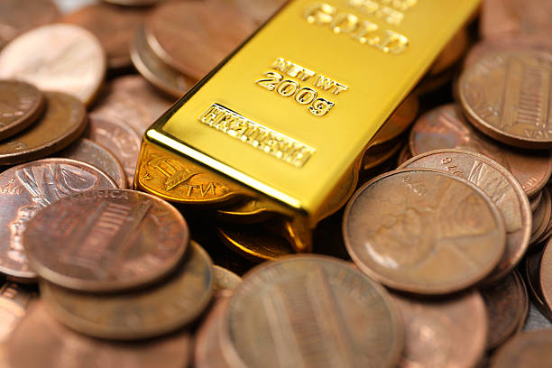 istock Gold bar on coins as background, closeup 2244791971