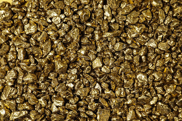 istock Shiny gold nuggets as background, top view 2244792559