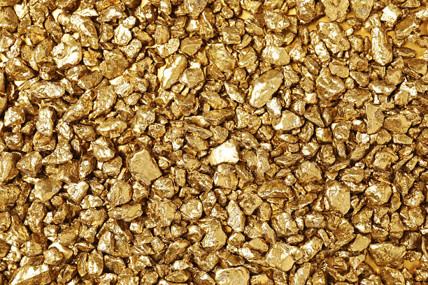 istock Shiny gold nuggets as background, top view 2244792591