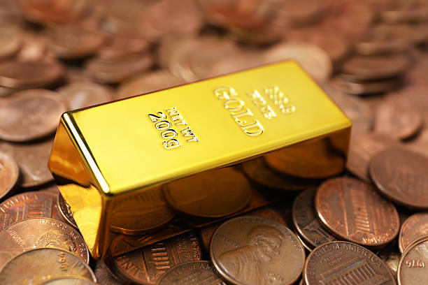 istock Gold bar on coins as background, closeup 2244792598