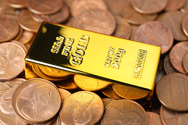 istock Gold bar on coins as background, closeup 2244793180