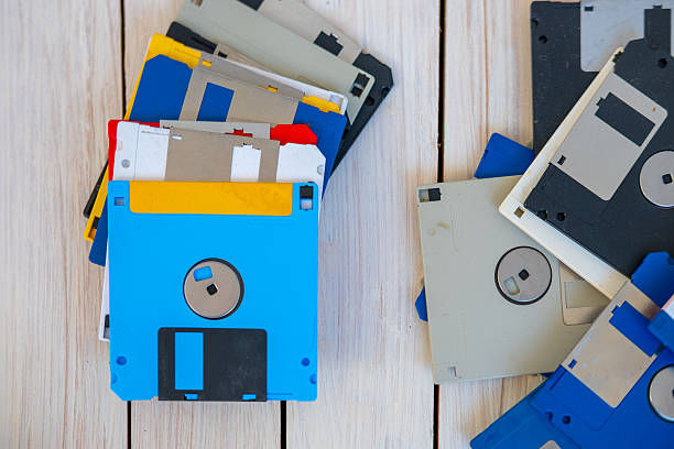 istock Colorful pile vintage 3.5 inch floppy disks on wooden surface, retro computing, obsolete data storage, tech nostalgia, digital history, collection old media formats 80s, 90s, nostalgic tech memory 2244794505