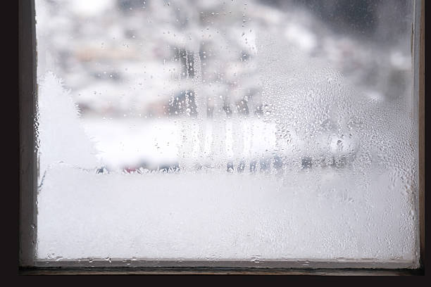 istock A beautiful, blurred winter landscape with snow-covered trees and white world visible through foggy, frosted window, symbolizing comfort and cold season, Winter comfort and coziness 2244794654