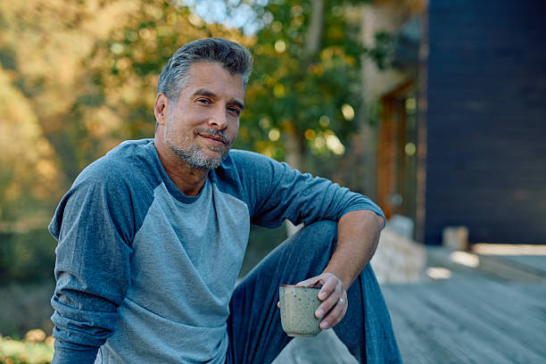 istock Mature man relaxing outdoors enjoying morning coffee 2244795666