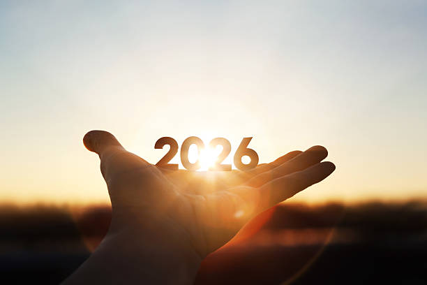 istock Bright sunlight shining through hands and sunrise background for New Year 2026 2244795823