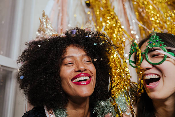Portrait of a young woman enjoying Carnival with friends at home