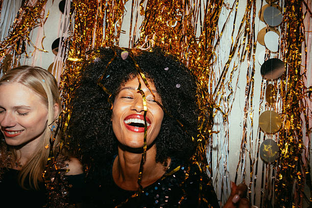 Photo of a couple of female friends celebrating the coming of a New Year's, together on a house party