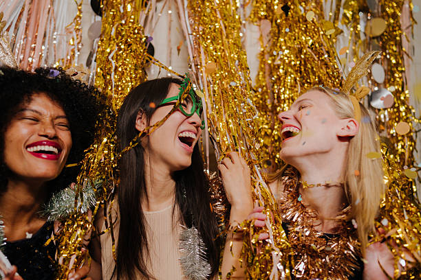 Photo of a group of female friends celebrating the coming of a New Year's, together on a house party