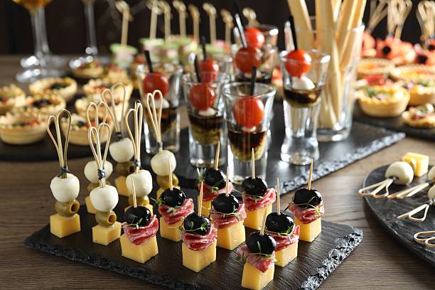 istock Many different tasty canapes on wooden table, closeup 2244797697