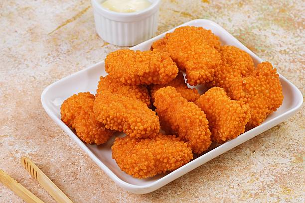istock Chicken nuggets served in white bowl with sauce cup 2244799377