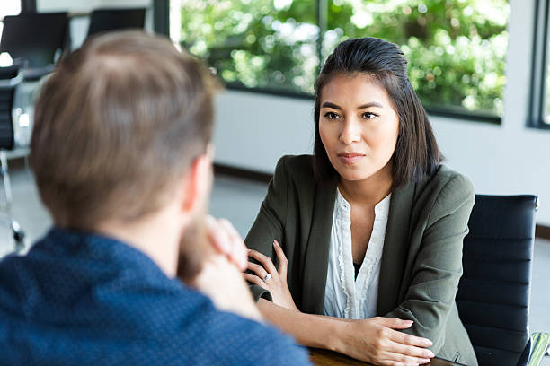 istock Serious discussion between two colleagues in a professional office setting during the day. 2244799492