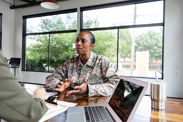 istock Military service member discusses important matters in a professional meeting setting. 2244799506