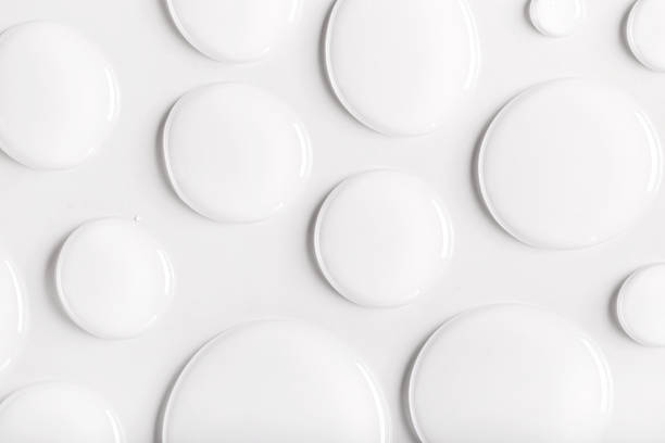 drops of transparent gel serum on gray background